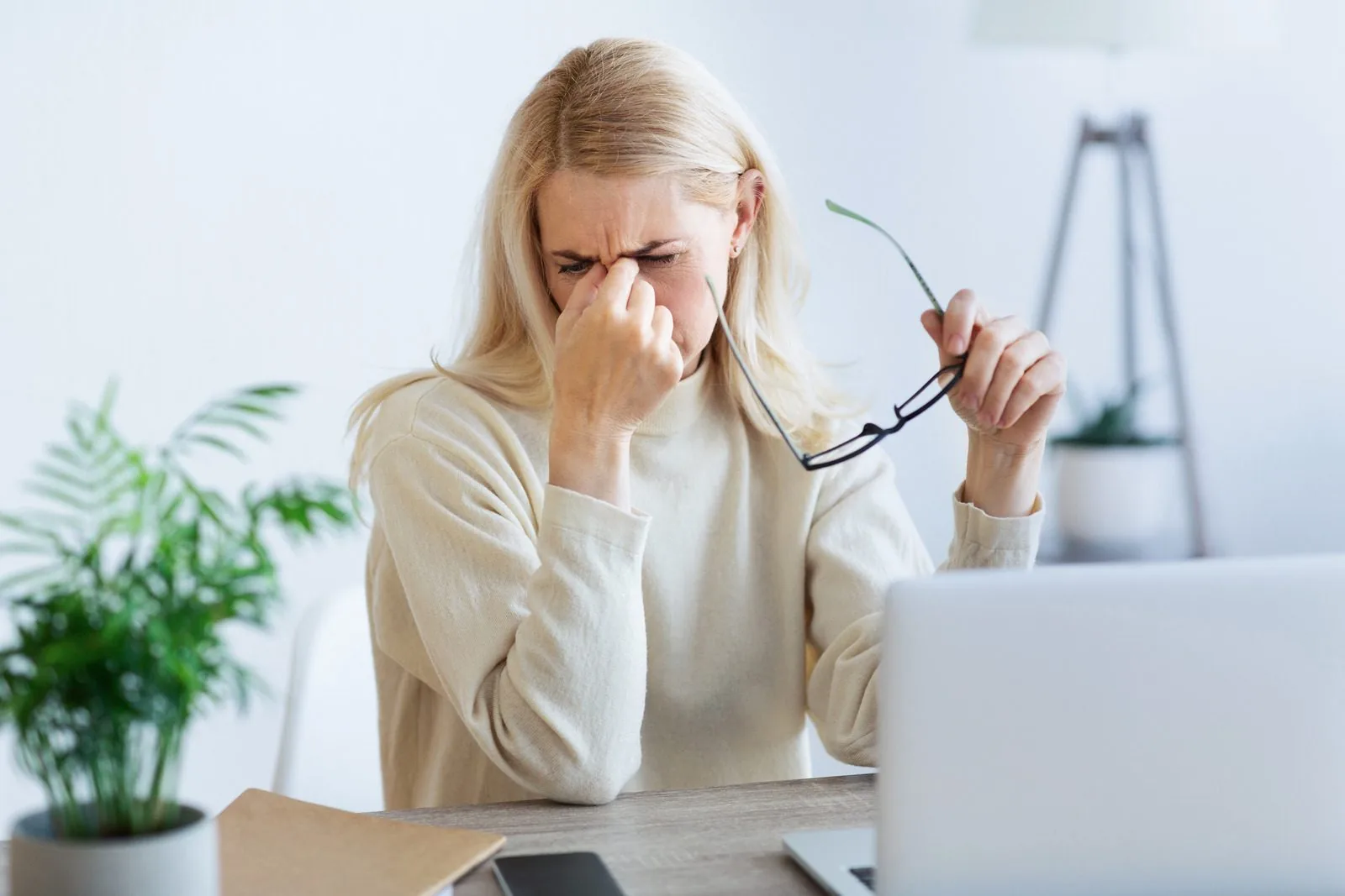 Woman with eye strain at her laptop